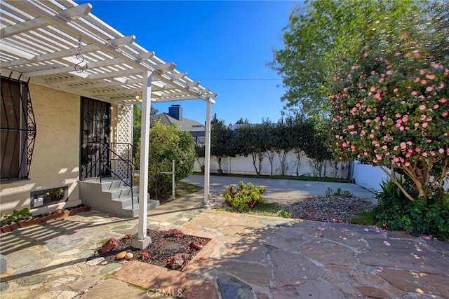 view of patio / terrace with a pergola and fence