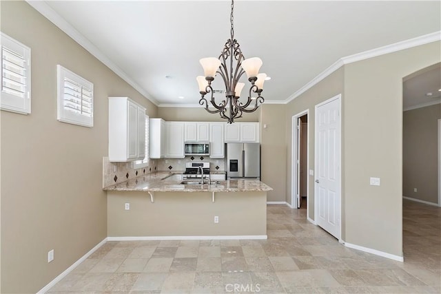 kitchen with a sink, stainless steel appliances, a peninsula, and white cabinets