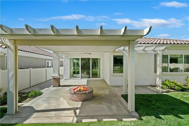 rear view of house with a patio, fence, an outdoor fire pit, a pergola, and stucco siding