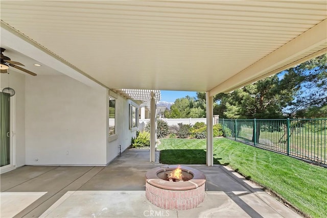 view of patio / terrace with an outdoor fire pit, a fenced backyard, and a ceiling fan