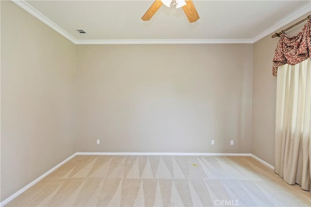 spare room with light colored carpet, baseboards, and ornamental molding