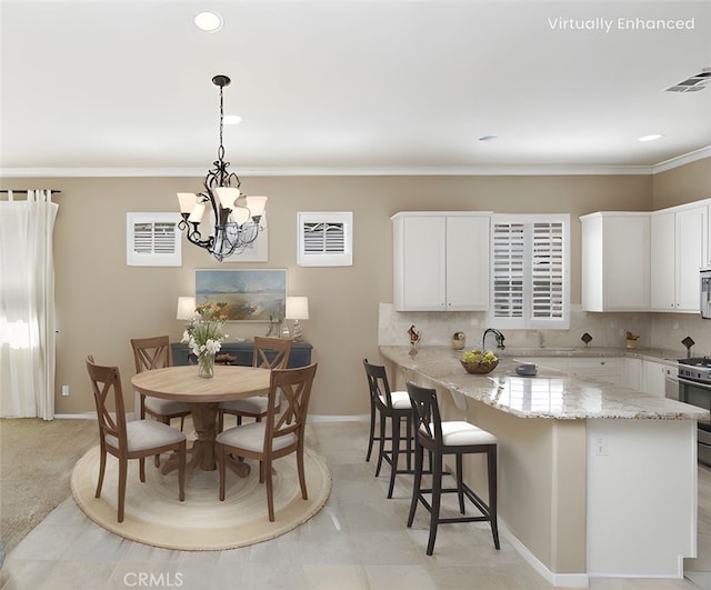 dining space with baseboards, visible vents, an inviting chandelier, recessed lighting, and ornamental molding