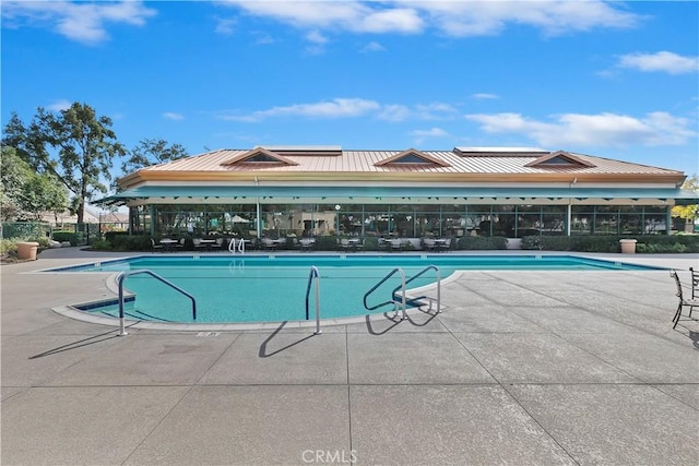 community pool featuring a patio and fence