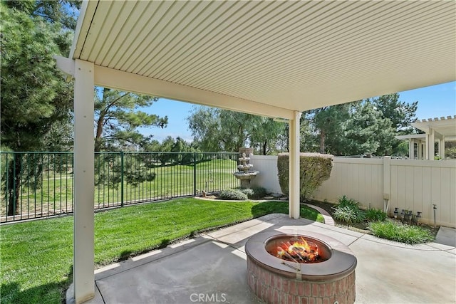 view of patio / terrace with a fire pit and a fenced backyard