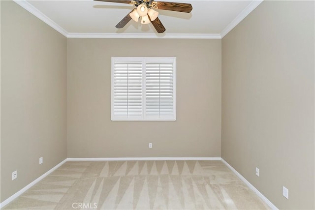 empty room featuring ceiling fan, baseboards, ornamental molding, and carpet flooring