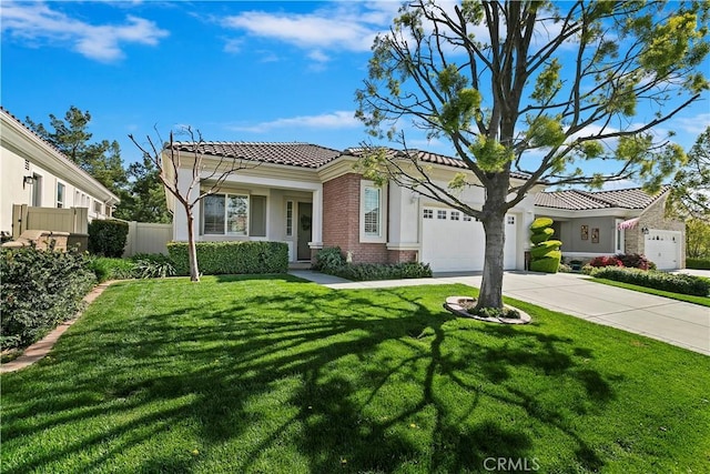 mediterranean / spanish-style home featuring fence, concrete driveway, a front lawn, a garage, and brick siding