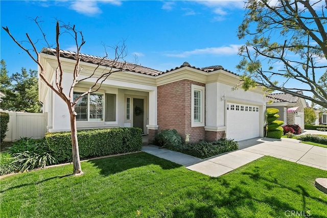 mediterranean / spanish-style home with driveway, an attached garage, a front lawn, a tile roof, and brick siding