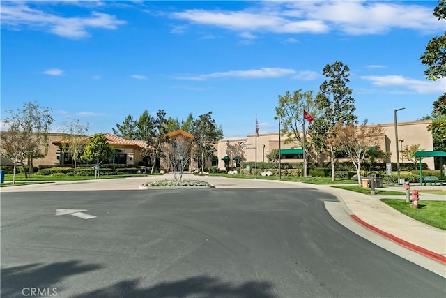 view of street with curbs, street lighting, and sidewalks