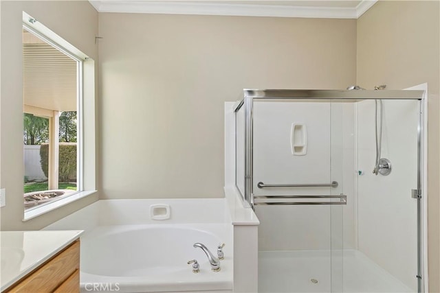 bathroom featuring a stall shower, vanity, a garden tub, and ornamental molding