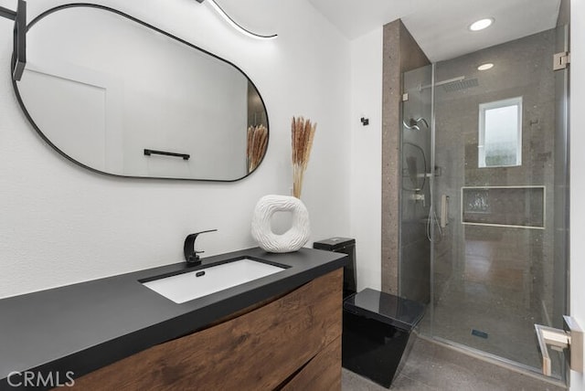 full bath featuring recessed lighting, a stall shower, and vanity