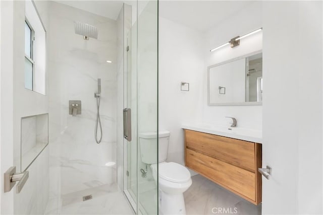 bathroom featuring vanity, toilet, and a marble finish shower