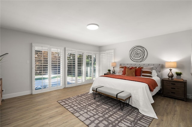 bedroom with baseboards and wood finished floors