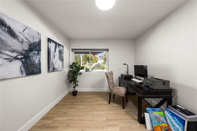 office area with light wood-type flooring and baseboards