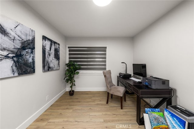 office area featuring baseboards and wood finished floors