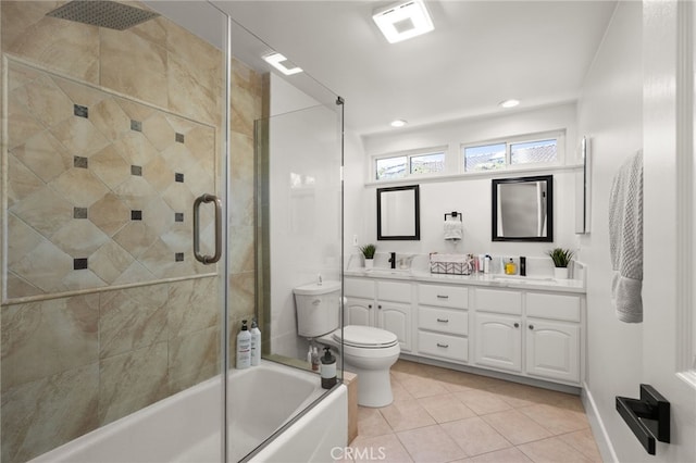 full bathroom with toilet, a sink, tile patterned flooring, double vanity, and bath / shower combo with glass door