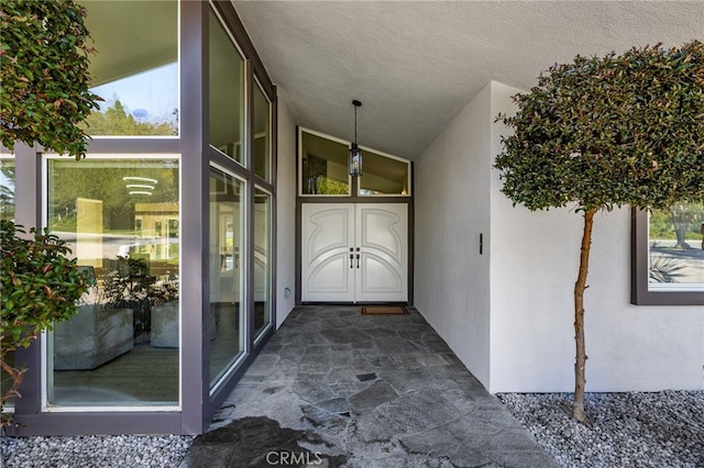 view of exterior entry featuring stucco siding