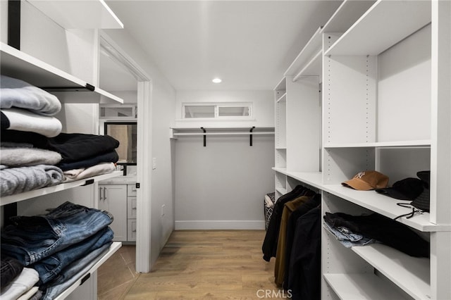 walk in closet featuring light wood finished floors