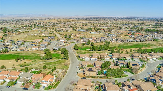 aerial view with a residential view, a mountain view, and view of golf course