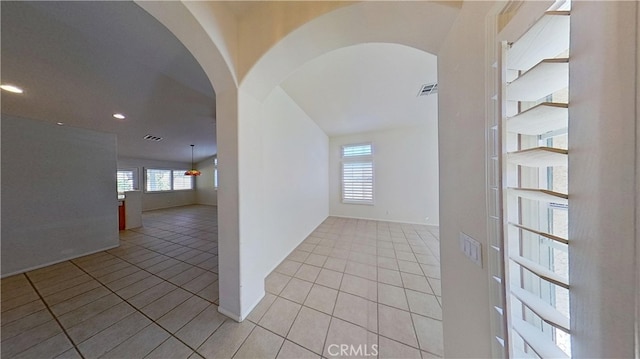 spare room featuring arched walkways, visible vents, recessed lighting, and light tile patterned floors