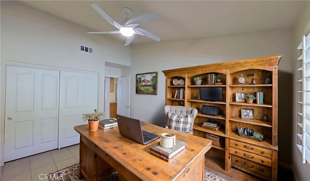 office space featuring light tile patterned floors, visible vents, ceiling fan, and vaulted ceiling