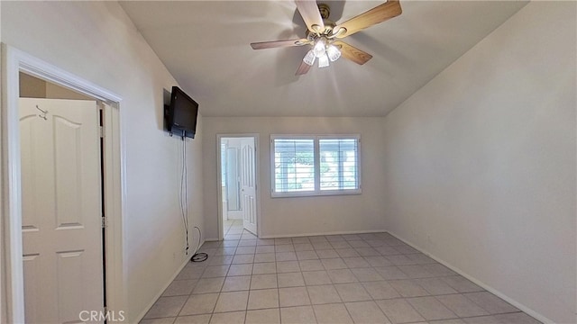 spare room featuring light tile patterned flooring, baseboards, and a ceiling fan