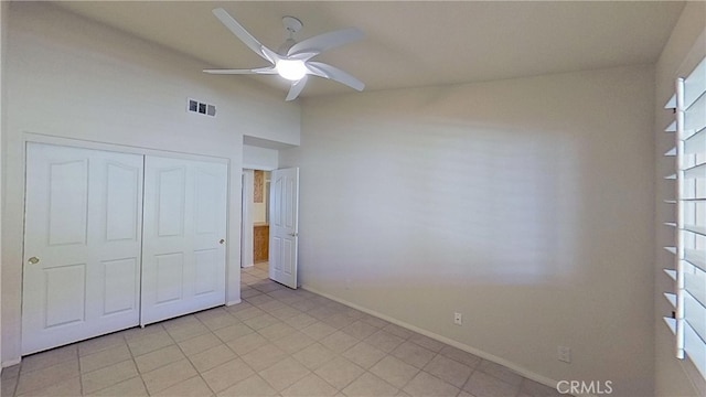 unfurnished bedroom featuring baseboards, visible vents, a closet, and ceiling fan