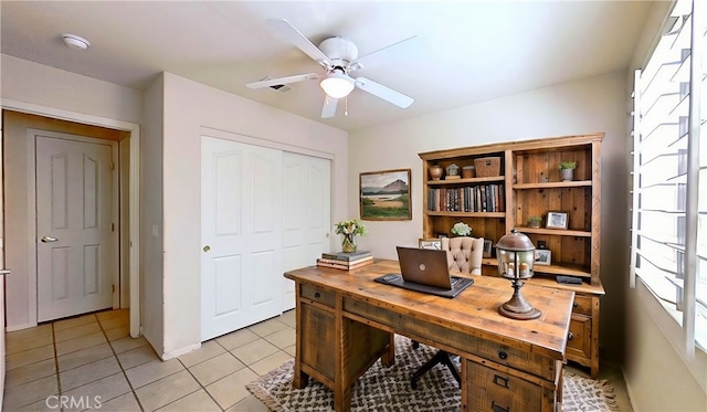 office space with light tile patterned floors and ceiling fan