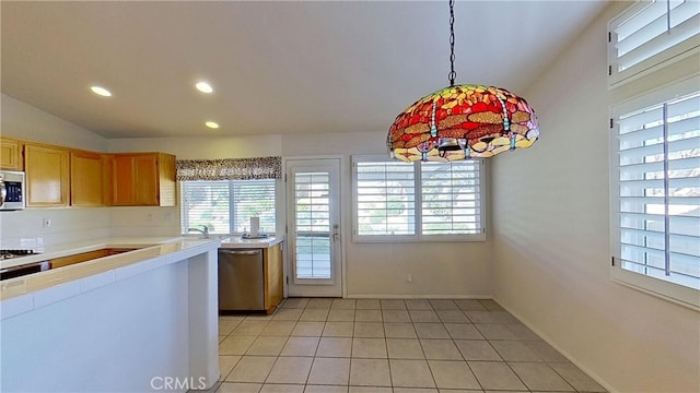 kitchen with recessed lighting, appliances with stainless steel finishes, light tile patterned flooring, baseboards, and hanging light fixtures