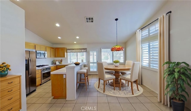 kitchen featuring stainless steel appliances, visible vents, light tile patterned flooring, and light countertops