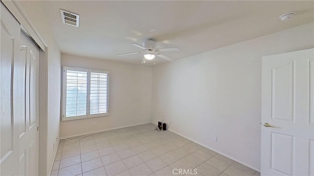 unfurnished room with visible vents, baseboards, and ceiling fan