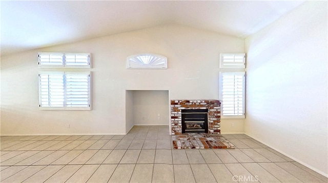 living room featuring a brick fireplace, light tile patterned floors, a healthy amount of sunlight, and high vaulted ceiling