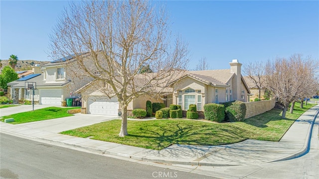 view of front facade with stucco siding, a front lawn, concrete driveway, a garage, and a tiled roof