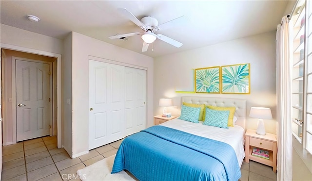 bedroom with a closet, ceiling fan, and light tile patterned flooring