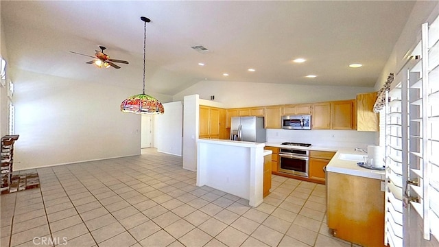 kitchen with visible vents, light countertops, lofted ceiling, appliances with stainless steel finishes, and a sink