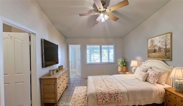 bedroom featuring ceiling fan, light tile patterned flooring, and vaulted ceiling