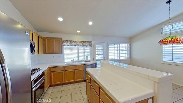 kitchen featuring light tile patterned floors, appliances with stainless steel finishes, and vaulted ceiling