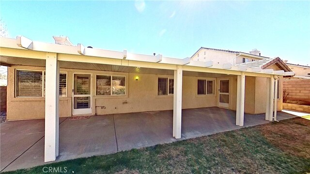 back of house featuring a patio area and stucco siding