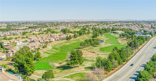 birds eye view of property with golf course view and a residential view