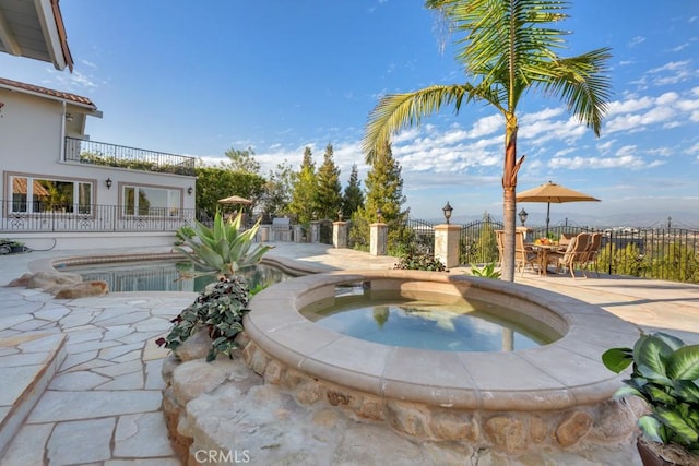 view of swimming pool with a patio, a fenced in pool, fence, an in ground hot tub, and outdoor dining area