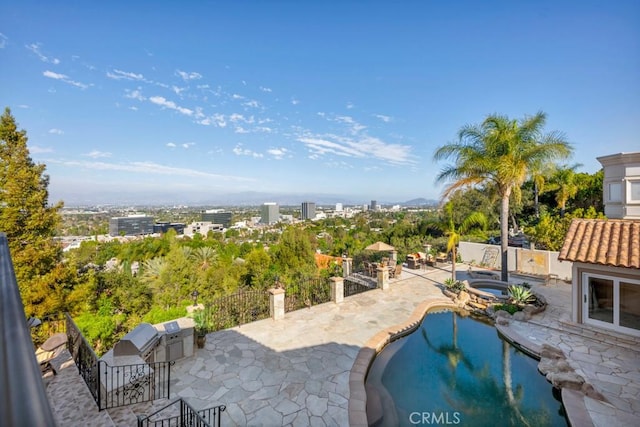 view of patio featuring exterior kitchen, a fenced in pool, fence, and an in ground hot tub