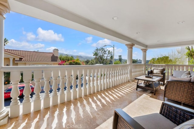 view of patio with an outdoor living space and a mountain view