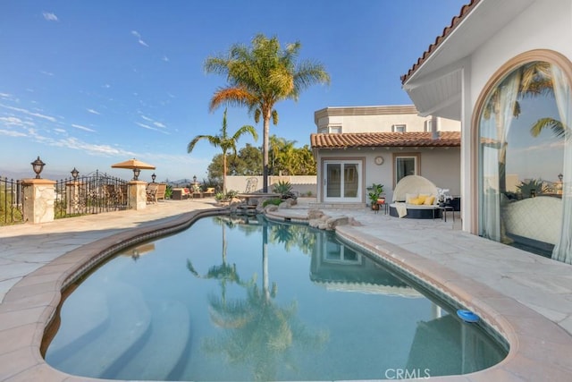 view of swimming pool with a patio area, a fenced in pool, and fence