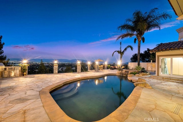 4440 Bergamo Dr, Encino, CA 91436 - pool at dusk with fence, exterior kitchen, a patio, and a fenced in pool