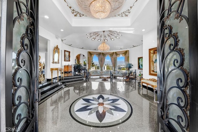 4440 Bergamo Dr, Encino, CA 91436 - entrance foyer with speckled floor, a tray ceiling, a chandelier, and recessed lighting