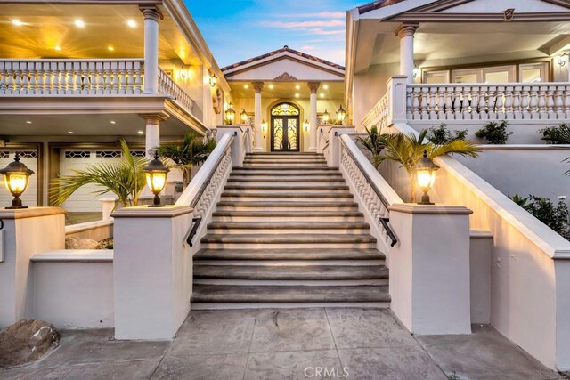 4440 Bergamo Dr, Encino, CA 91436 - exterior entry at dusk with a balcony and french doors