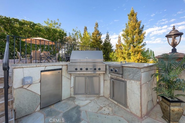 view of patio / terrace featuring area for grilling and exterior kitchen