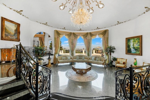 interior space featuring speckled floor, arched walkways, an inviting chandelier, and stairway