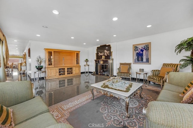 living area with recessed lighting, a fireplace, and ornamental molding