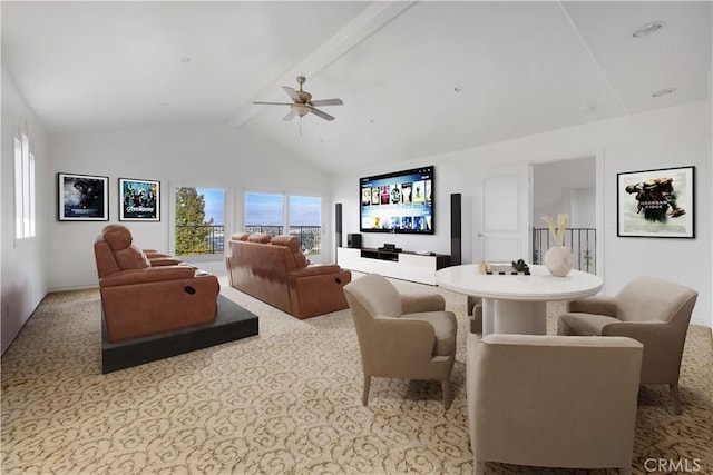 cinema room featuring lofted ceiling with beams, ceiling fan, and carpet flooring