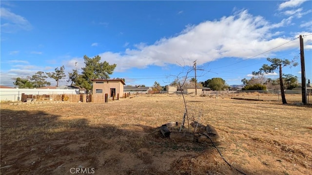 view of yard featuring a rural view and fence